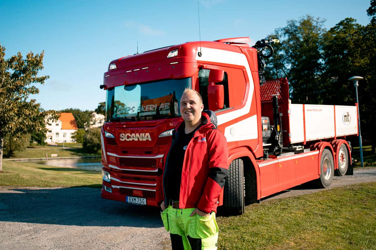 Medarbetare framför lastbil i park